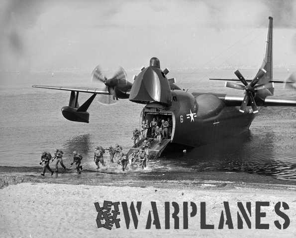 Another promotional shot of the beach landing demonstration with marines storming through the coastal water. (Consolidated Vultee photo)