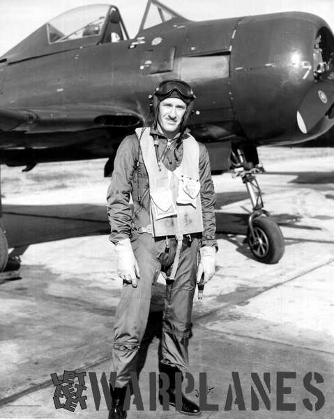 Lt Commander John Gray of VF-66 in his flying clothes standing in front of an FR-1