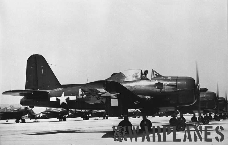 A row of factory fresh Fireballs. Note Grumman Hellcats on the background!